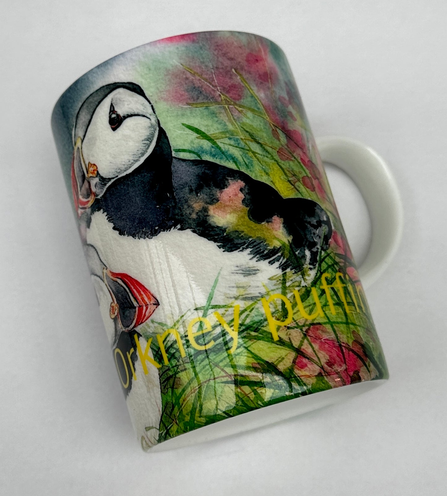 bone china mug printed with a watercolour painting of puffins