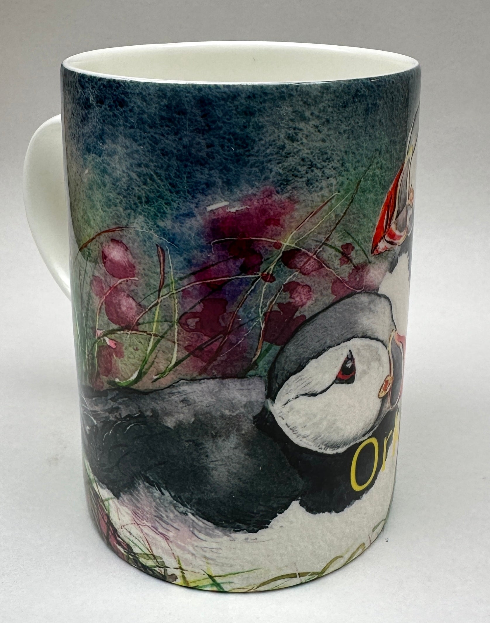 bone china mug printed with a watercolour painting of puffins