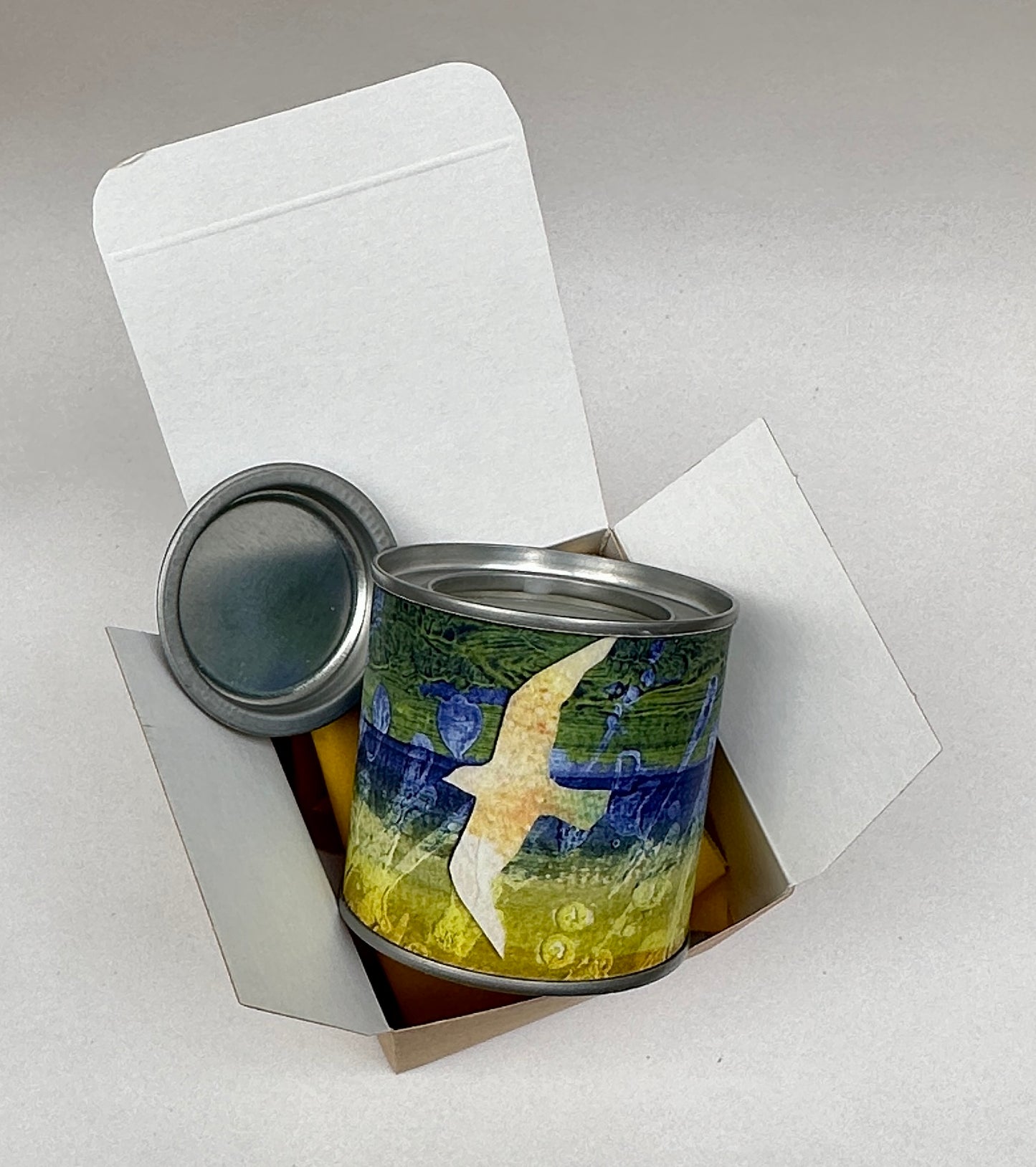 Small candle in a tin/Blue green yellow landscape with gull