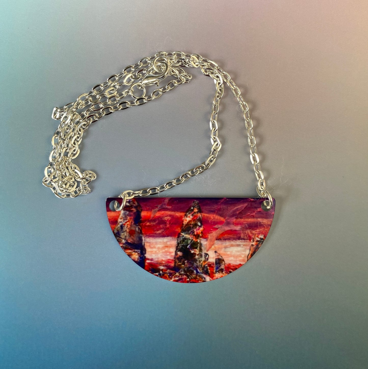 A pendant neckclace with design, A wild sunset at The Ring of Brodgar by Orkney artist Jane Glue, Scotland