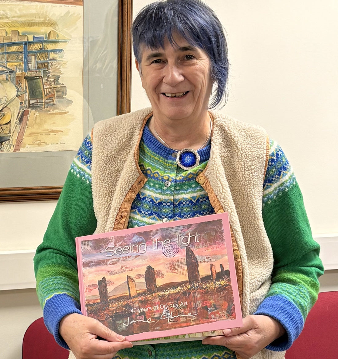 Orkney artist Jane Glue with her new book 'Seeing the light' 40 years of Orkney art which was published in November 2025.