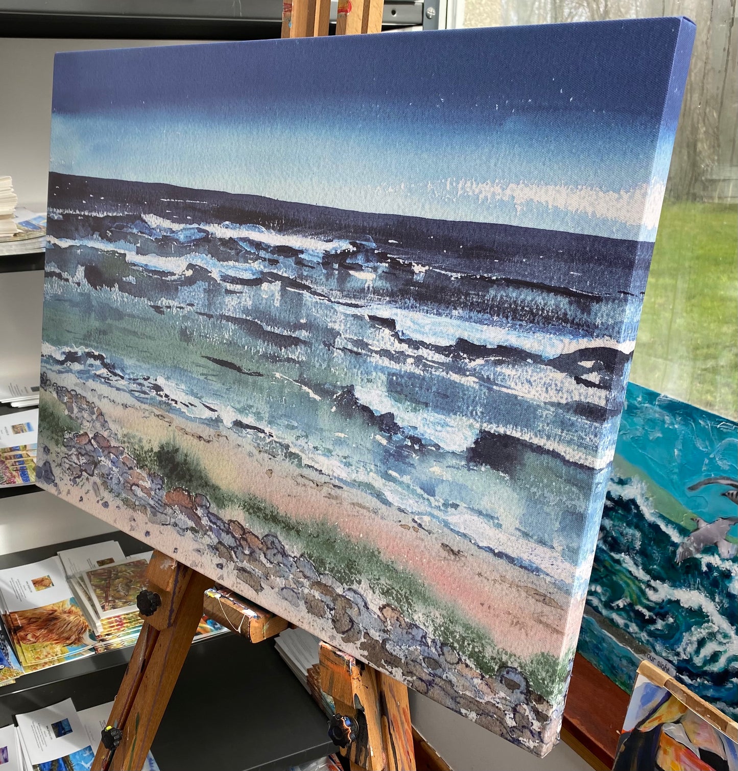 A print on canvas taken from an original watercolour painting of blue waves on the Westray shoreline by artist Jane Glue from Orkney, Scotland