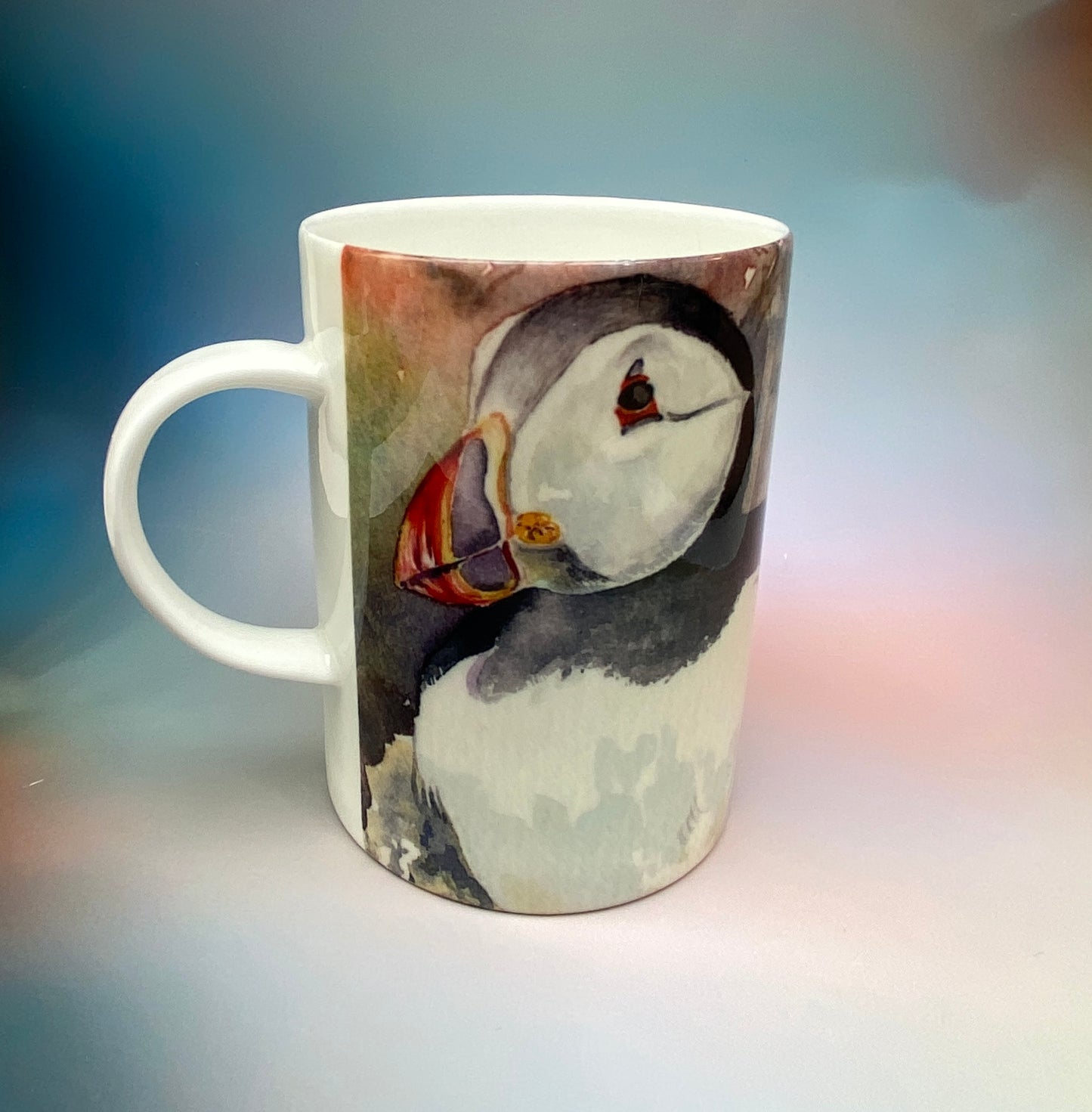 A mug with a puffins design by Orkney artist Jane Glue, Scotland