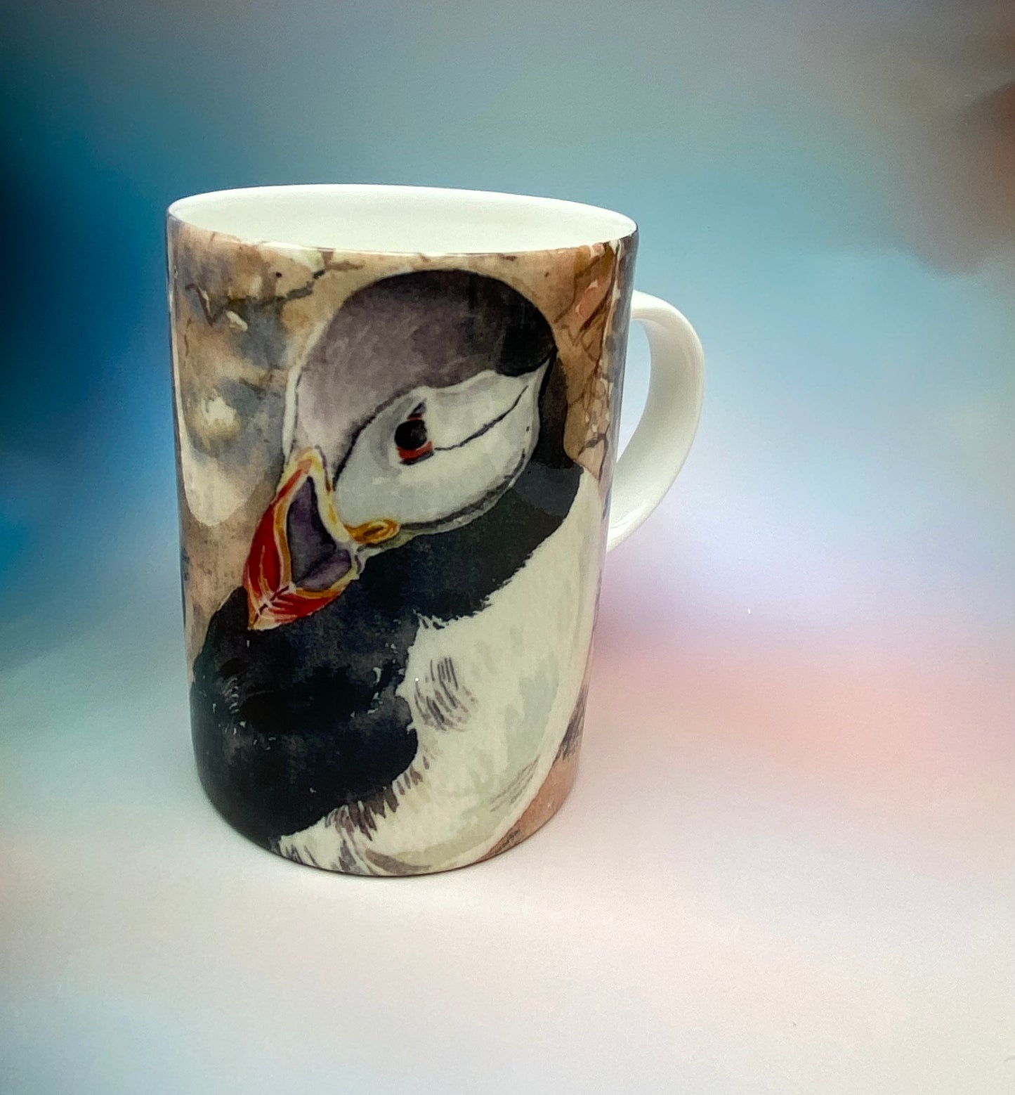 A mug with a puffins design by Orkney artist Jane Glue, Scotland