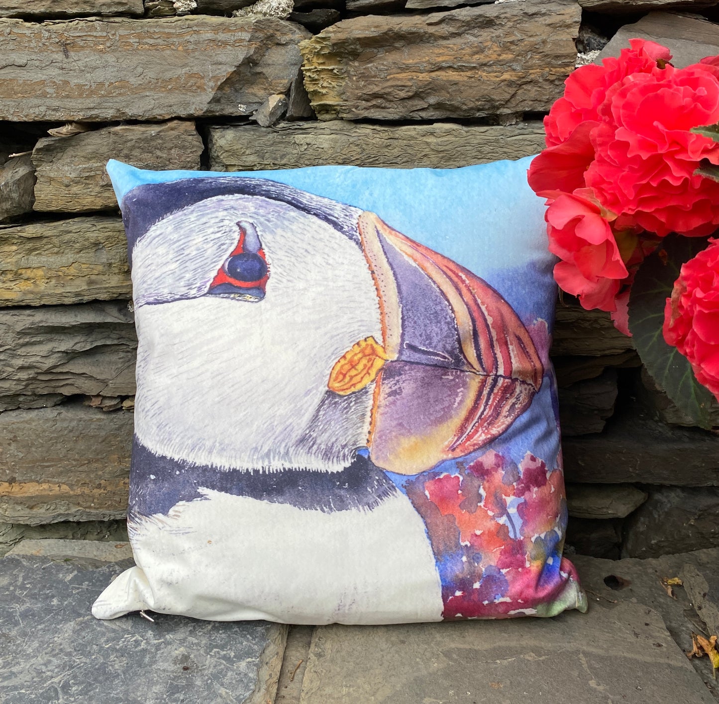 A beautiful velvet cushion printed with a watercolour image of a puffin's head by Orkney artist Jane Glue, Scotland