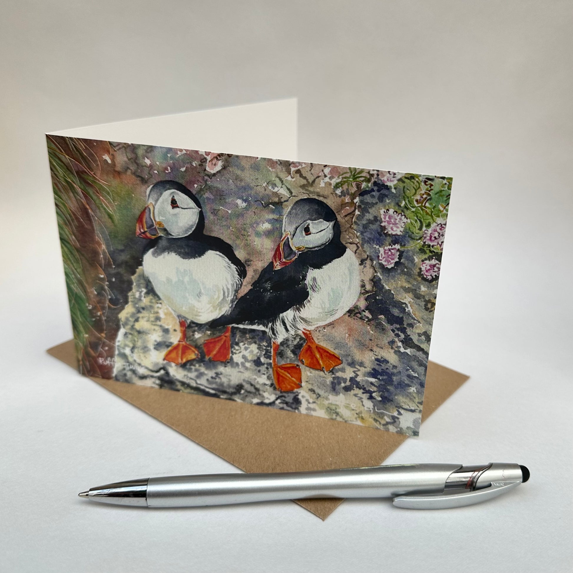 Folded card of two Orkney puffins standing on a cliff in westray