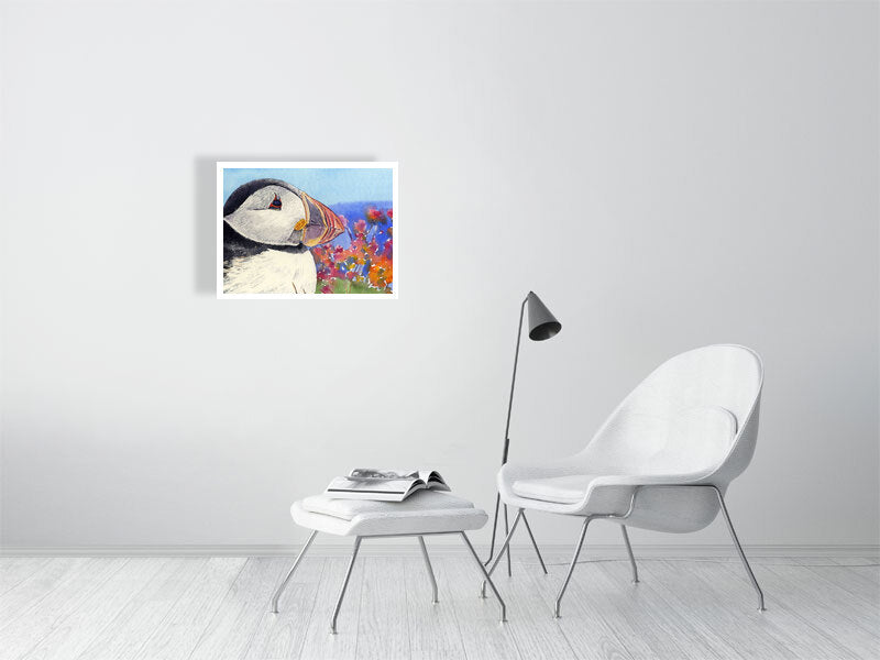 a limited edition print of a watercolour painting of a puffins head with its rainbow coloured beak and seapinks in the background
