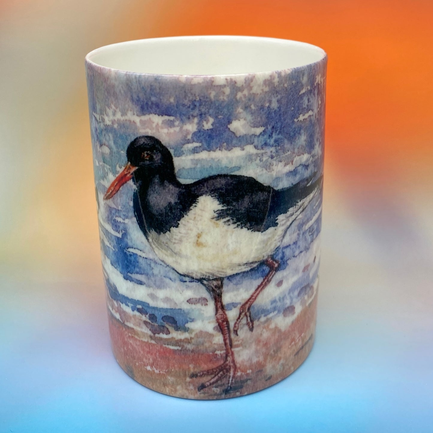 A mug with a oystercathers design by Orkney artist Jane Glue, Scotland